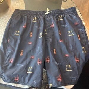 Travis Mathew Navy Swim Shorts with Red and Yellow Tropical Prints